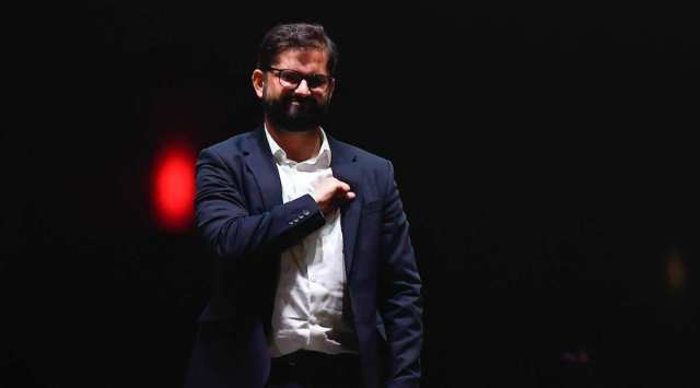 Chile's President elect Gabriel Boric, of the "I approve Dignity" coalition, gestures to his supporters after his victory in the presidential run-off election in Santiago, Chile, Sunday, Dec. 19, 2021. (AP Photo/Matias Delacroix)