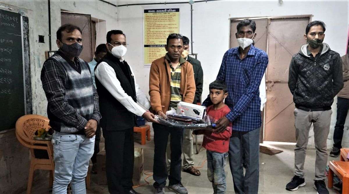 A  student receives school merchandise and sweaters on Tuesday. (Express Photo by Bhupendra Rana)