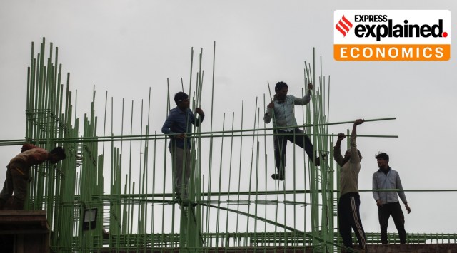 Laborers work at a building construction site in Mumbai, Tuesday, Nov. 30, 2021. (AP Photo/Rafiq Maqbool)