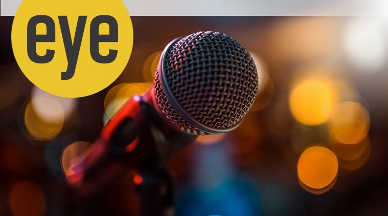 close-up stage microphone with blurry lights in the background