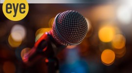 close-up stage microphone with blurry lights in the background