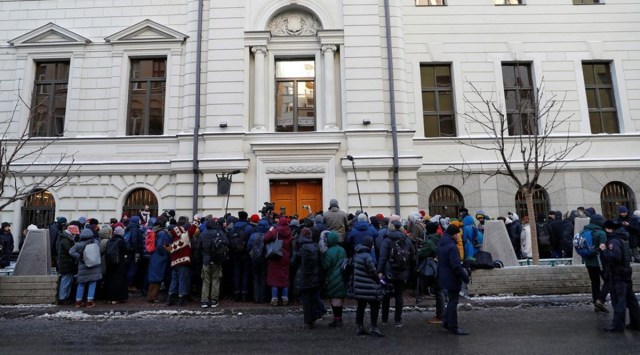 Supporters of the human rights group International Memorial and journalists gather outside a court building during a hearing of the Russian Supreme Court to consider the closure of International Memorial in Moscow, Russia December 28, 2021. (Reuters)