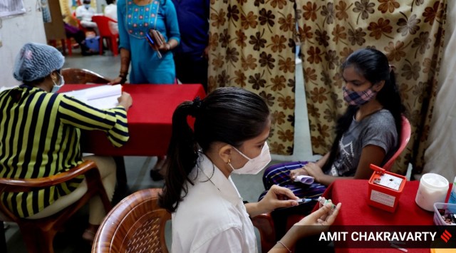 A beneficiary gets a shot of a Covid-19 vaccine in Navi Mumbai. (Express Photo by Amit Chakravarty)