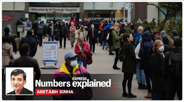 People queue in a line, at right, to go for coronavirus booster jabs at St Thomas' Hospital, in London, Monday, Dec. 13, 2021. (AP Photo/Matt Dunham)