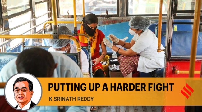 A municipal  corporation worker administers a dose of Covid-19 vaccine to a beneficiary in Navi Mumbai (Express photo by Narendra Vaskar)
