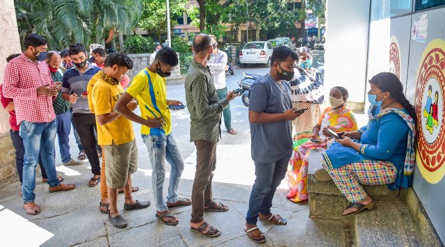 Beneficiaries wait to receive a dose of COVID-19 vaccine at a government hospital amid fear of spread of 'Omicron variant' in Bengaluru, Friday, Dec. 10, 2021. (PTI Photo)