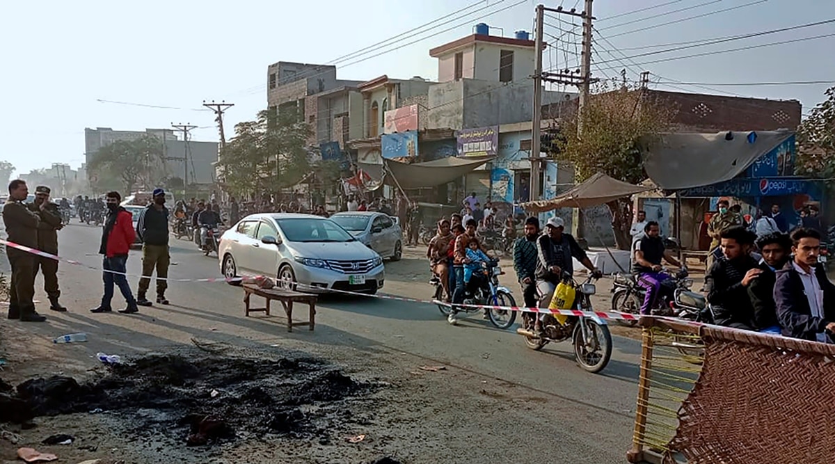 Police officers stand guard at the site where a Sri Lankan citizen was lynched by a mob in Sialkot, Pakistan, Friday, Dec. 3, 2021. (AP)