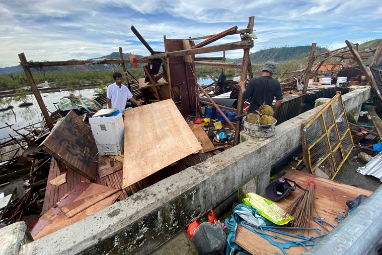 Residents salvage what's left of their belongings at their damaged home due to Typhoon Rai in Surigao city, Surigao del Norte, central Philippines on Friday Dec. 17, 2021. (AP)