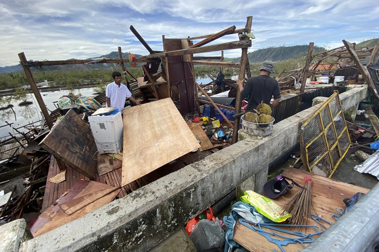 Residents salvage what's left of their belongings at their damaged home due to Typhoon Rai in Surigao city, Surigao del Norte, central Philippines on Friday Dec. 17, 2021. (AP)