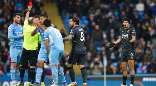 Wolverhampton Wanderers' Raul Jimenez, right, receives a red card from referee Jonathan Moss during the English Premier League soccer match between Manchester City and Wolverhampton Wanderers, at the Etihad stadium in Manchester, England, Saturday, Dec.11, 2021. (AP Photo/Dave Thompson)