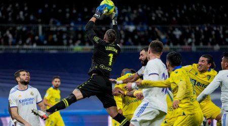 Cadiz's goalkeeper Jeremias Ledesma dives for the ball during the La Liga soccer match between Real Madrid and Cadiz at Santiago Bernabeu stadium in Madrid, Spain, Sunday, Dec. 19, 2021. (AP Photo/Bernat Armangue)