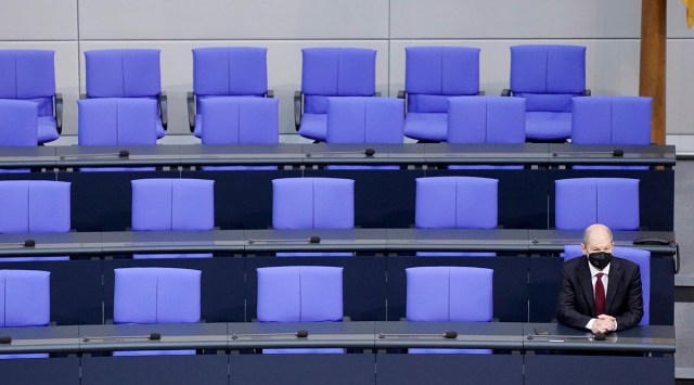 German Chancellor Olaf Scholz sits alone on the government bench after being sworn in as new German Chancellor in the German Parliament Bundestag in Berlin, Dec 8, 2021.  (AP)