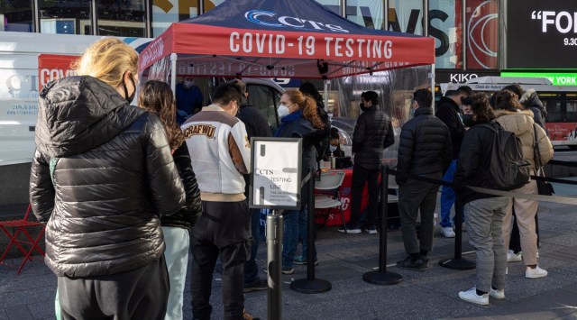 People wait in line at a Covid-19 testing site at Times Square on Friday. (Photo: AP)