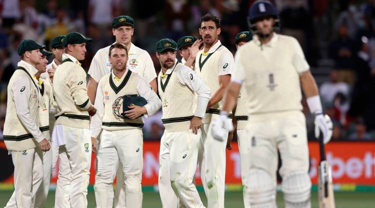 Australian players watch as England's Joe Root, right, leaves the field after he was dismissed by Mitchell Starc. (AP)