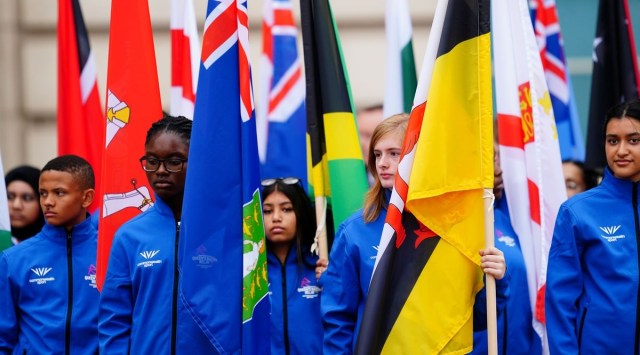 People carry flags at the launch of the Commonwealth Games baton relay, outside Buckingham Palace in London. (Reuters)