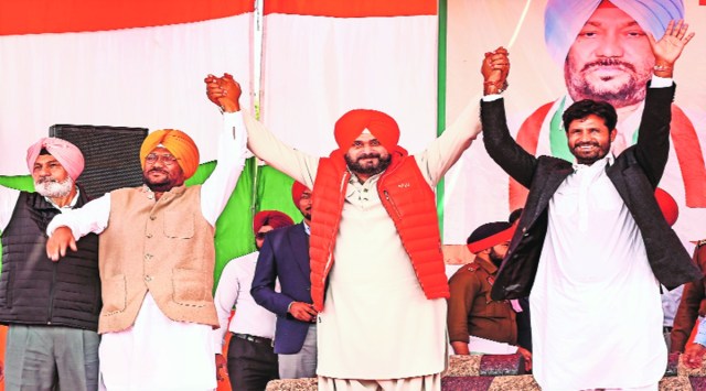 Punjab Congress president Navjot Singh Sidhu with Transport Minister Amarinder Singh Raja Warring during Congress rally in Bathinda, Monday. PTI