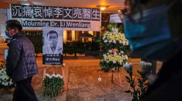 People wearing masks attend a vigil for late Li Wenliang, an ophthalmologist who died of coronavirus at a hospital in Wuhan, in Hong Kong, China February 7, 2020. (Reuters/File)