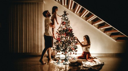 Family decorating Christmas tree.