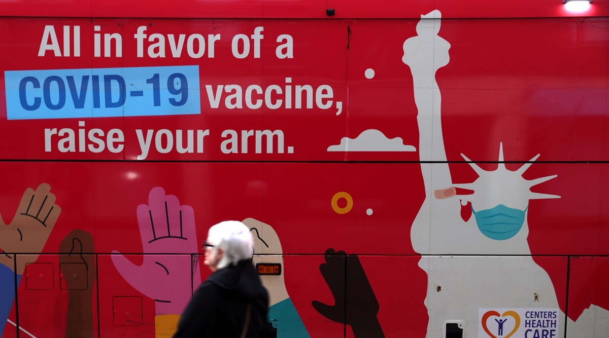 A person walks past a mobile coronavirus disease vaccine clinic during the spread of the Omicron coronavirus variant in Manhattan, New York, US on Dec 7, 2021. (Reuters)