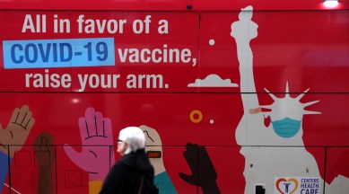 A person walks past a mobile coronavirus disease vaccine clinic during the spread of the Omicron coronavirus variant in Manhattan, New York, US on Dec 7, 2021. (Reuters)