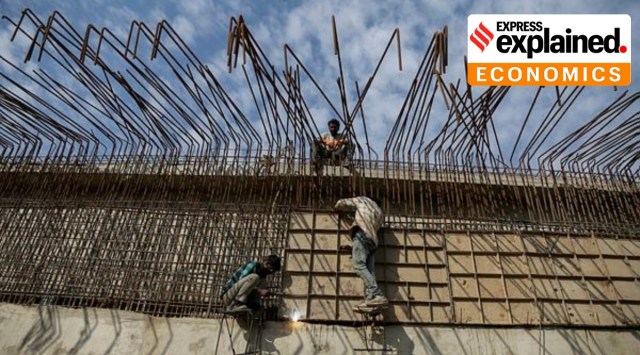 Laborers work at a flyover construction site in Jammu, Tuesday, Nov. 30, 2021. (AP Photo)