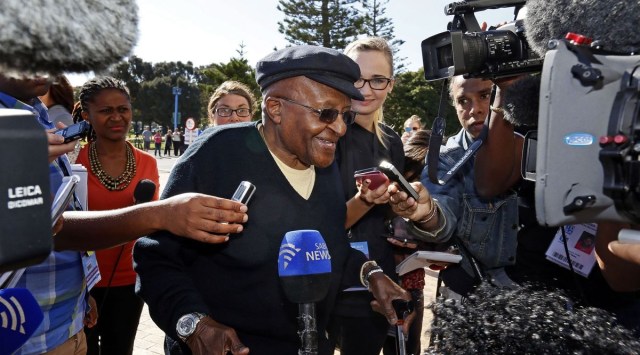 Archbishop Desmond Tutu speaks to the media as he arrives to cast his vote during the South African election in Cape Town May 7, 2014. REUTERS/Mark Wessels