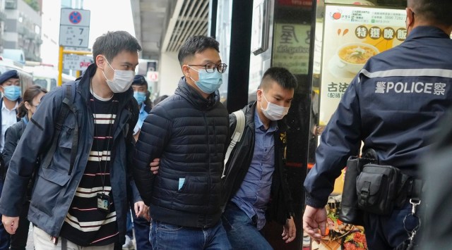 Editor of "Stand News" Patrick Lam, second from left, is arrested by police officers in Hong Kong. (AP)
