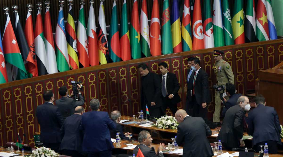 Pakistan Prime Minister Imran Khan, center, leave after his speech during the 17th extraordinary session of Organization of Islamic Cooperation (OIC) Council of Foreign Ministers, in Islamabad, Pakistan, Sunday, Dec. 19, 2021. The economic collapse of Afghanistan, already teetering dangerously on the edge, would have a "horrendous" impact on the region and the world, successive speakers warned Sunday at the start of a one-day summit of foreign ministers. (AP Photo/Rahmat Gul)