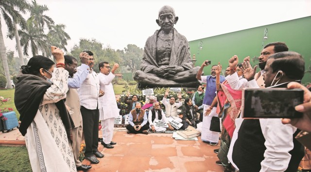 Opposition members protest in front of the Gandhi statue at Parliament. (Express Photo Anil Sharma)