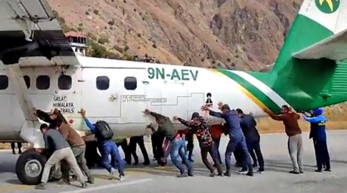 nepal, nepal airport plane pushing, passengers push plane, tara air, tara air plane tyre burst, odd news, viral videos, indian express