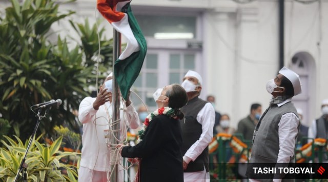Congress leader Sonia Gandhi holds the party flag in hand after it fell from the flag post.  (Express photo by Tashi Tobgyal)