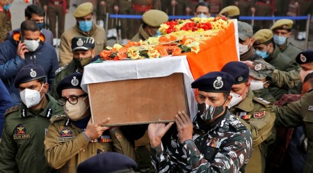 Police officers carry the body of constable Rameez Ahmad Baba during a wreath laying ceremony on the outskirts of Srinagar Dec 14, 2021. (Reuters)
