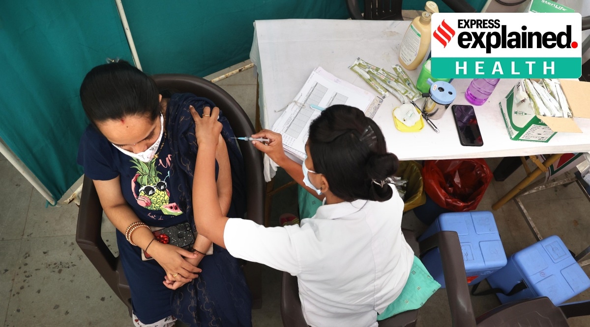 A health worker vaccinates a beneficiary at an urban primary health centre in Nerul, Navi Mumbai. (Express Photo: Amit Chakravarty)