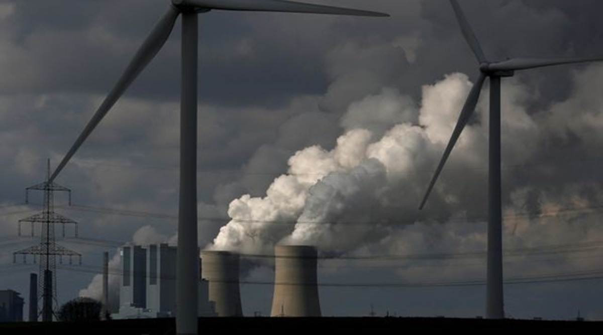 Wind turbines are seen in front of a coal power plant of German utility RWE Power near the western town of Neurath. (Reuters/File)