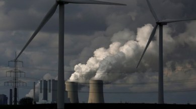 Wind turbines are seen in front of a coal power plant of German utility RWE Power near the western town of Neurath. (Reuters/File)