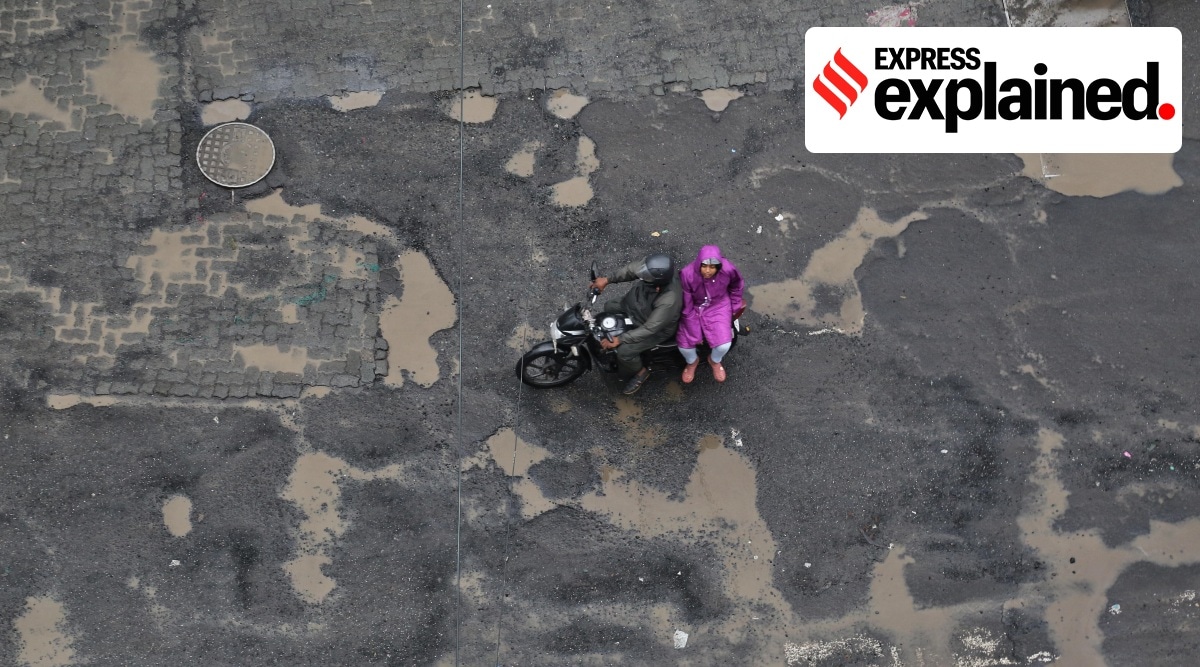 This 2019 photograph shows potholes on a road in Andheri East during the rains. The BMC wards look after repaid of roads, among various other tasks. (Express Photo: Amit Chakravarty, File)