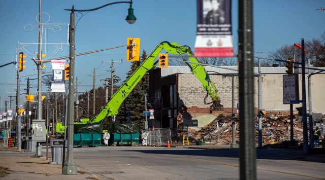 A crew works on Dec. 13, 2021, to demolish a building next to the site of last summerÕs gas explosion in Wheatley, Ontario, Canada. The explosion, in a community built on 19th-century gas wells, has left locals searching for answers and some certainty that their town will ever recover. (Tara Walton/The New York Times)
