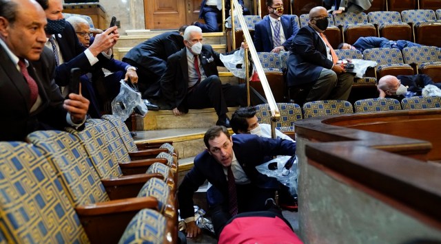 Members of Congress shelter in the House gallery as rioters try to break into the House Chamber at the US Capitol on Jan. 6, 2021, in Washington. (AP)