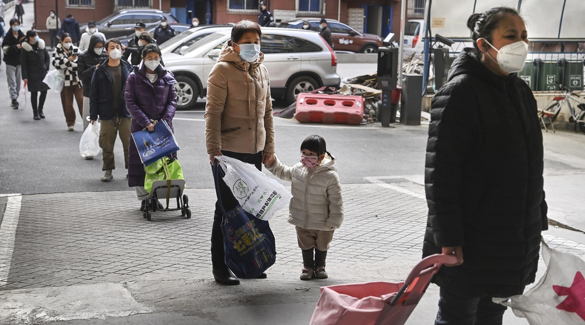 Residents wearing masks line up to receive necessities donated by warm-hearted people in Xi'an, in northwestern China's Shaanxi Province, Jan. 10, 2022. Xi'an, a city of 13 million people, is one of the Chinese city currently under lock down because of Covid-19 outbreak. (AP)
