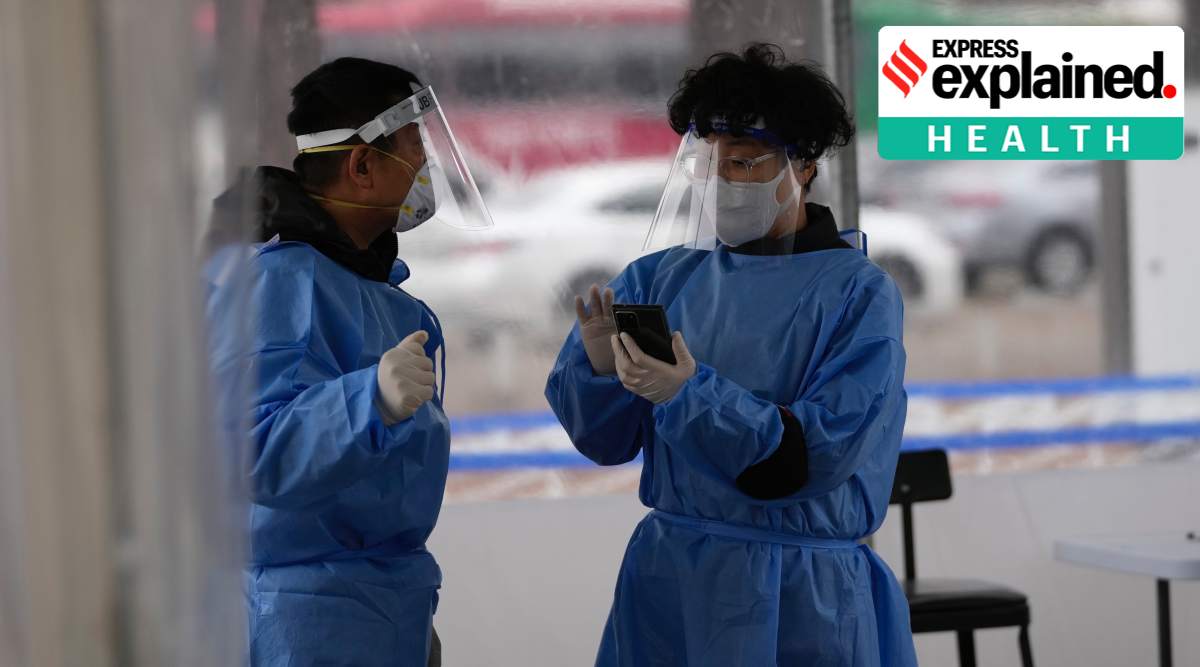 Health workers wearing protective gear prepare for visitors at a temporary screening clinic for the coronavirus in Seoul, South Korea, Tuesday, Jan. 25, 2022. (AP Photo/Lee Jin-man)


