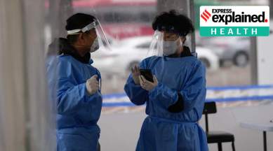 Health workers wearing protective gear prepare for visitors at a temporary screening clinic for the coronavirus in Seoul, South Korea, Tuesday, Jan. 25, 2022. (AP Photo/Lee Jin-man)