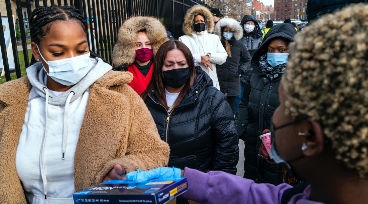 People line up and receive test kits to detect Covid-19 as they are distributed in New York on Dec. 23, 2021. (AP)