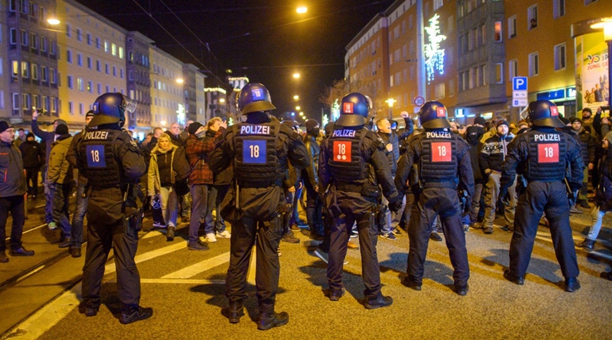 Police officers and and participants of a meeting face each other in the city center of Magdeburg, Germany, Monday evening, Jan. 3, 2022. (AP)