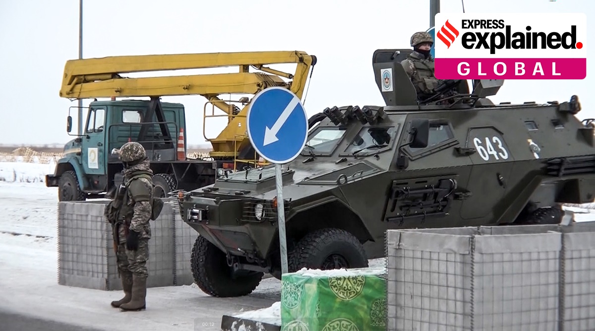 A Kazakhstan soldier stands next to a military vehicle at a check point on Friday. (Photo: AP)