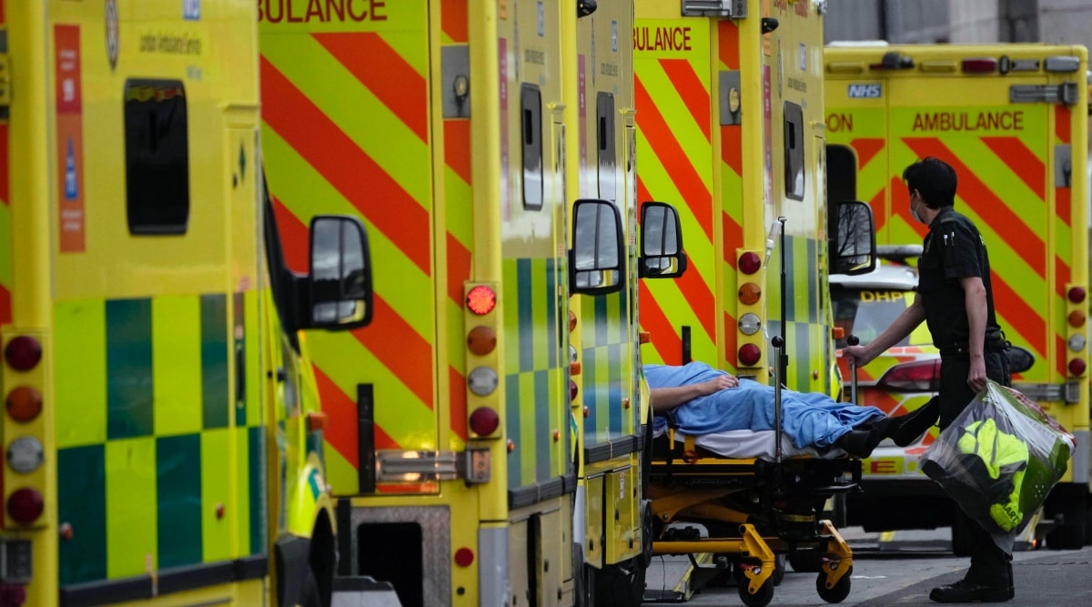 A patient is pushed on a trolley after arriving in an ambulance outside the Royal London Hospital in the Whitechapel area of east London, Jan. 6, 2022. (AP Photo/Matt Dunham, File)
