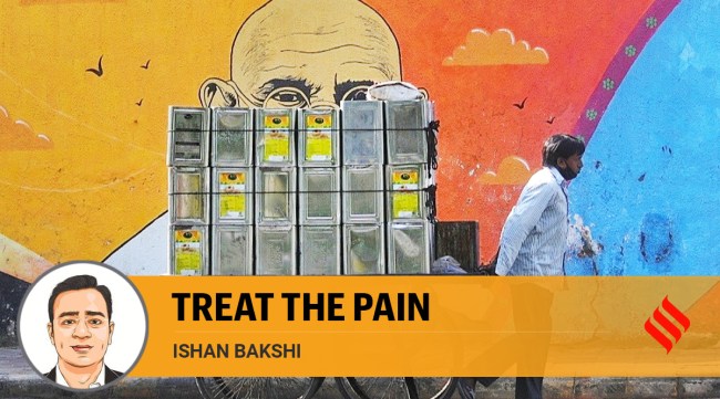 A man pulls his cart passed street art of Mahatma Gandhi in Ahmedabad. (Express Photo: Nirmal Harindran)