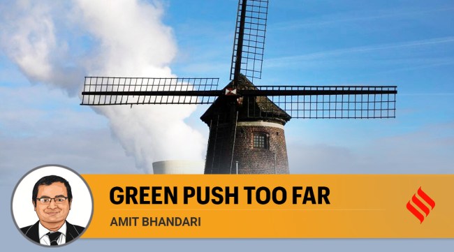 Steam rises from a nuclear power station behind an old windmill on the River Scheldt in Doel, Belgium. (AP Photo/Virginia Mayo, File)