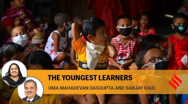 Children wear mask at an anganwadi on the outskirts of Agartala in 2020. (Express Photo: Abhisek Saha, File)