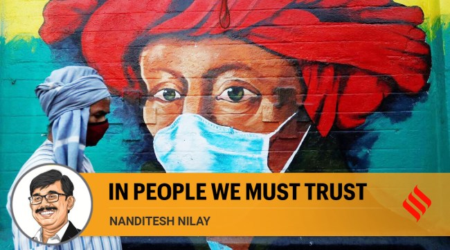 A man walks past a mural on a street amidst the spread of COVID-19 in Mumbai. (Reuters)