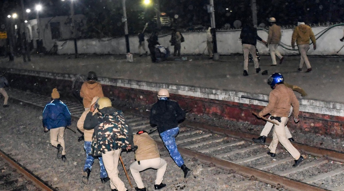 Police chase the aspirants who blocked railway tracks to protest over alleged erroneous results of RRB NTPC exam, at the Rajendra Nagar Terminal railway station, in Patna, Monday, Jan. 24, 2022. (PTI Photo)